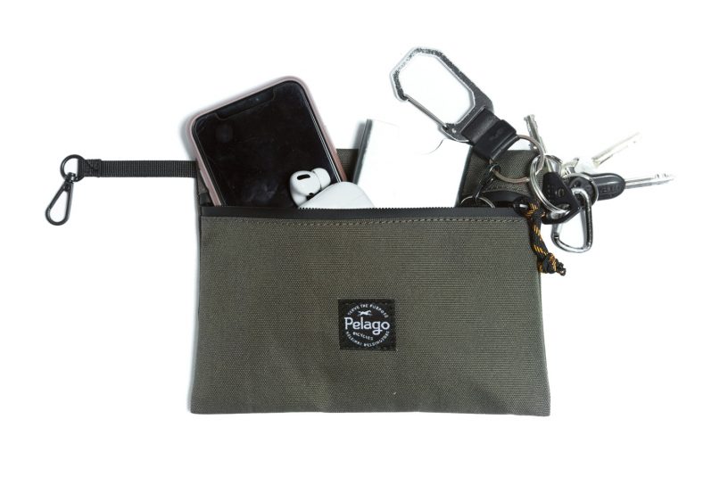 A green pouch with supplies inside.