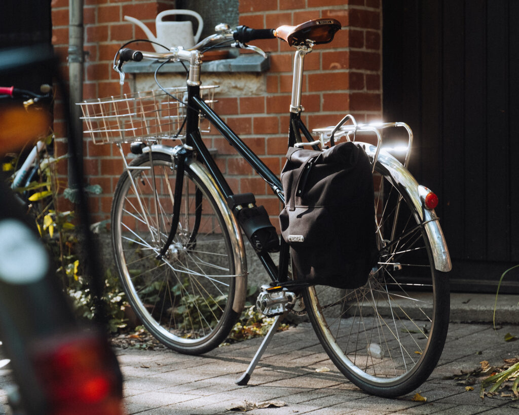 A bicycle with a rear rack and panniers. 